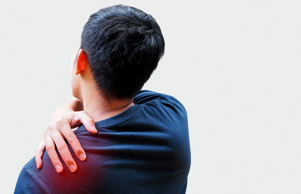 young man holding his left shoulder due to pain