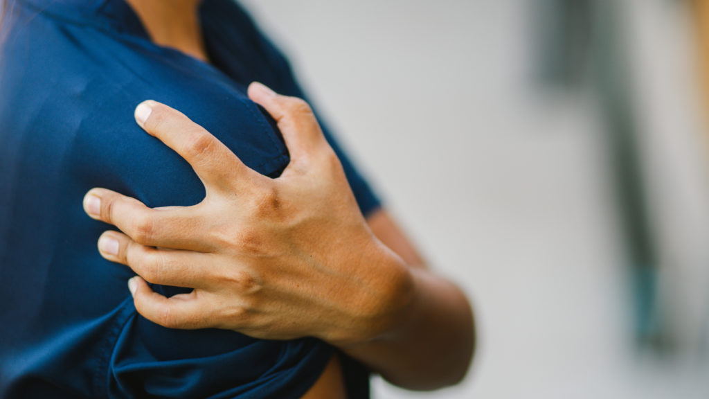 young man suffer from shoulder pain