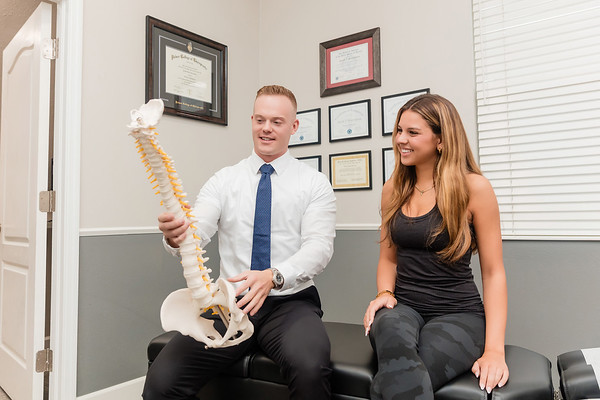 Dr. Jacob Henricksen showing a full spine model to his patient