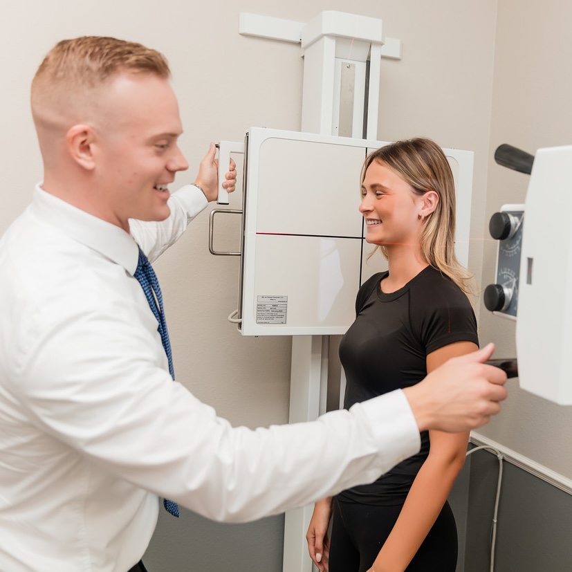 Dr. Jacob Henricksen assisting a patient with spinal X-ray imaging